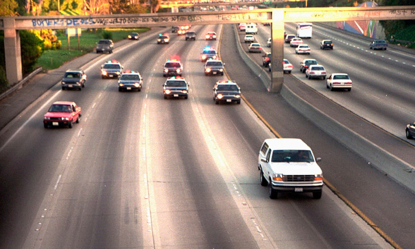 A white Ford Bronco, driven by Al Cowlings carrying OJ Simpson, is trailed by Los Angeles police cars as it travels on a freeway in Los Angeles. The pursuit was shown live on TV. Photo / AP