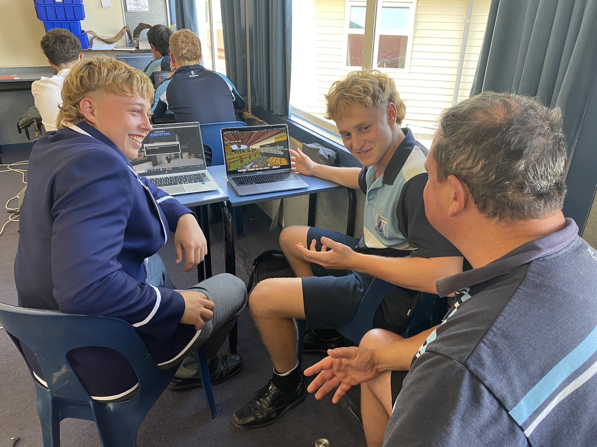  Napier Boys’ High School agricultural teacher Rex Newman discusses calf rearing with Year 13 students Riley Mullaney and George Rickey during testing of the newest agricultural and science curriculum resource, Mātiki Minecraft.  Photo / Supplied