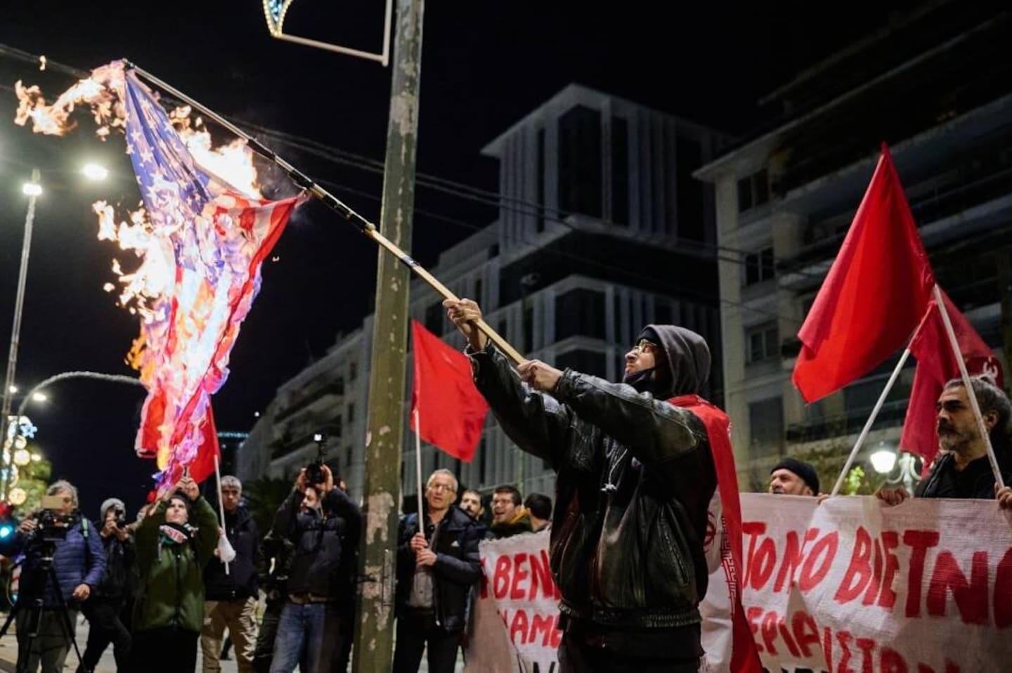 A protester holds a burning US flag during a demonstration organised by members of Greek Comunist party (KKE) against the recent US operation in Venezuela that resulted in the capture of the Venezuelan President, near the US consulate in Thessaloniki. Photo / Aggelos Nakkas, AFP
