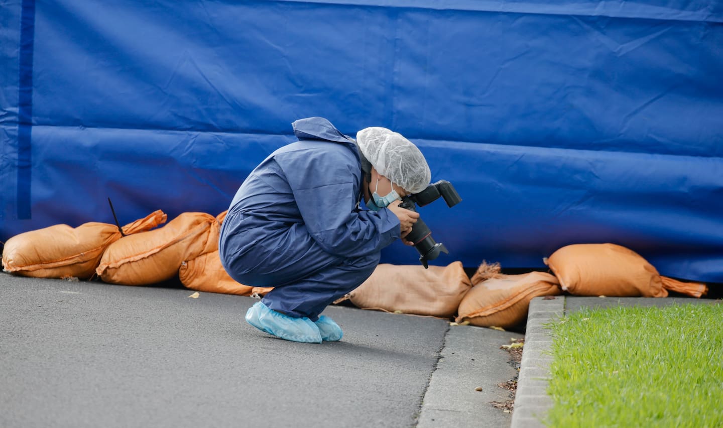 A police photographer gathers evidence. Photo / Alex Burton