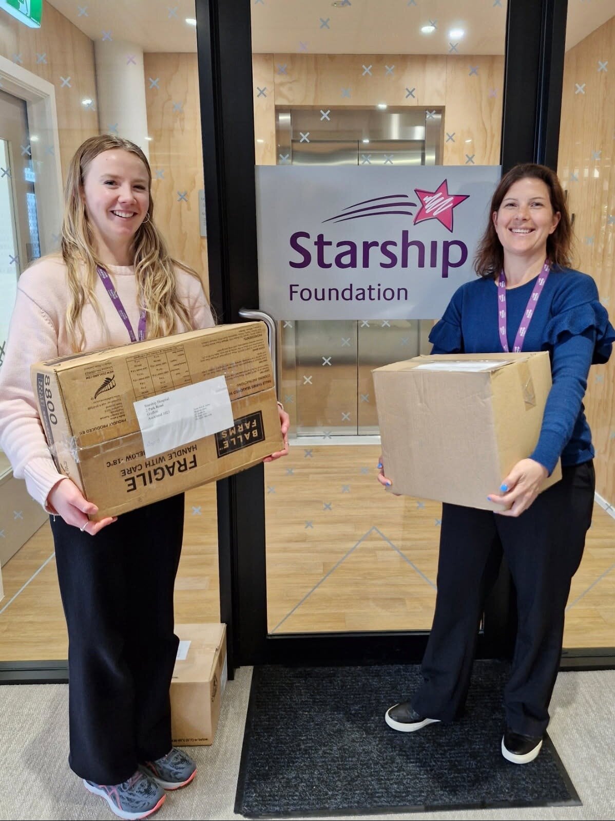 Ceili Lea (left), and Rebecca Oliver of the Starship Foundation with boxes of donations from Te Puke Kinit and Natter group. Photo / Starship Foundation