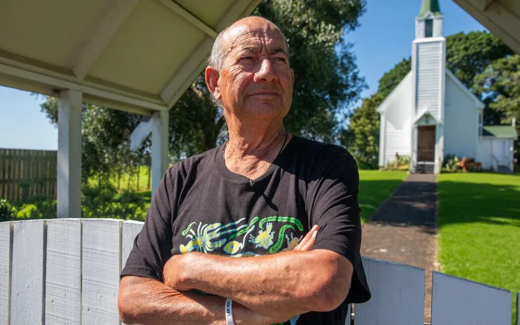 Tommy Wilson carries a golf club while walking around Te Puna to fend off roaming and aggressive dogs. Photo / RNZ, Nick Monro