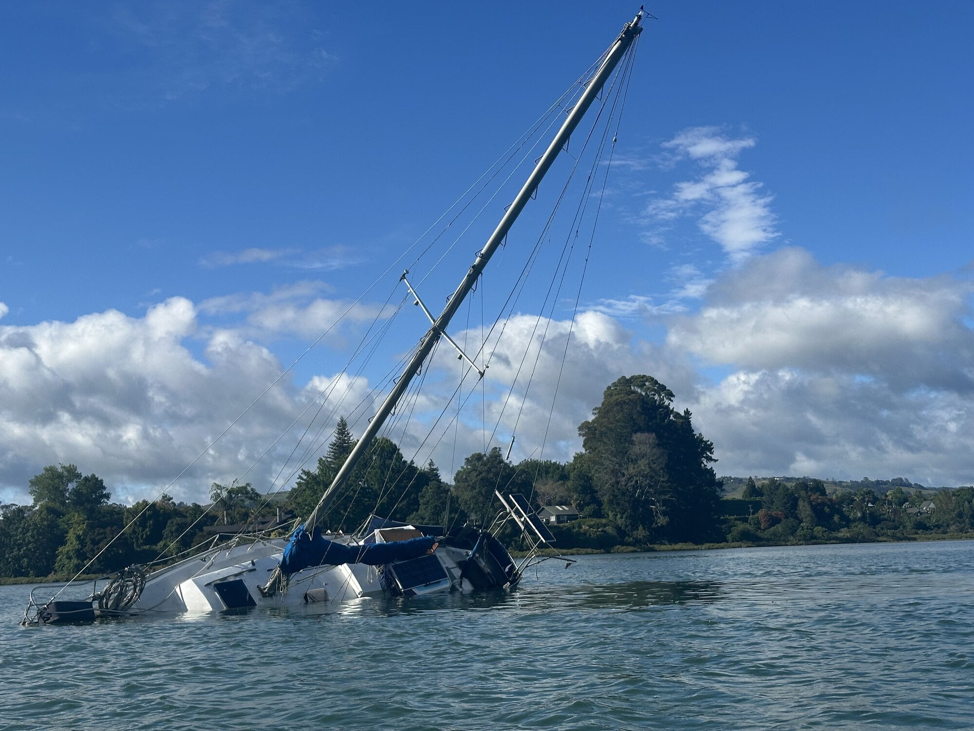 The yacht is listing to one side in the Te Puna Estuary in the Western Bay of Plenty. Photo / Claire Rogers