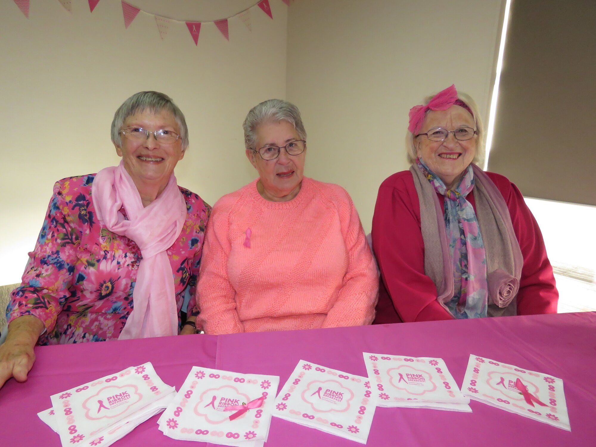 Ladies in pink Lois Shaw, Maureen Middleton and Jane Lawn enjoy catching up at the pink breakfast fundraiser. Photo / Merle Cave