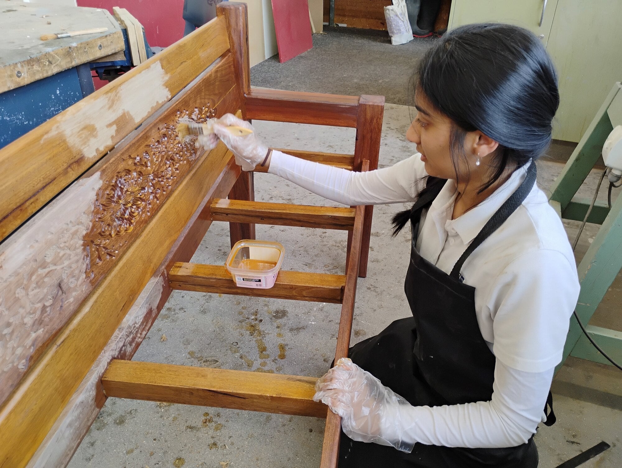 Ōtūmoetai College student Zainab Harmine working on the floral lattice pattern of her seat.