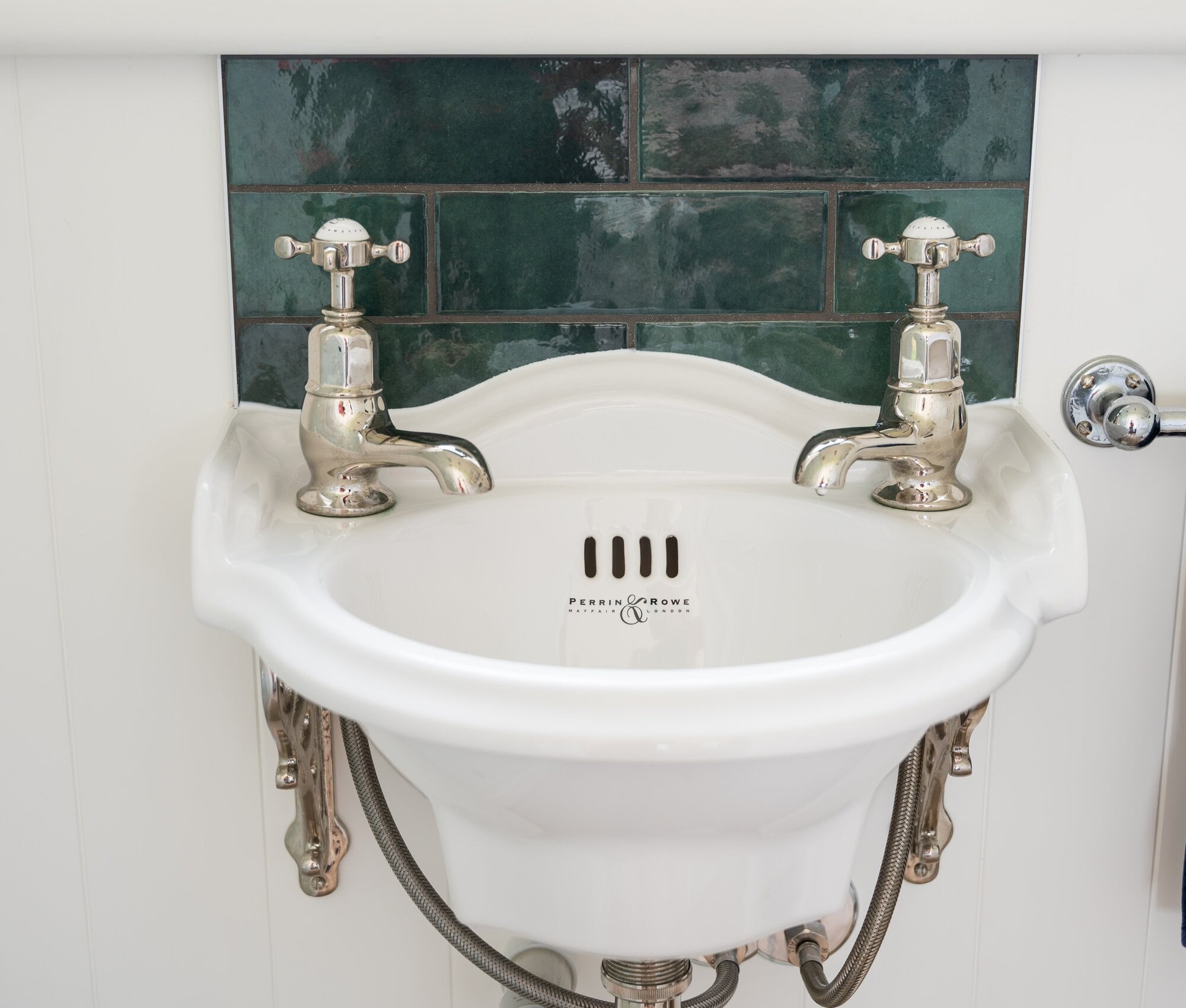  The 50mm by 200mm British racing green splashback tiles around the vintage-style sink. Photo / Brydie Thompson.