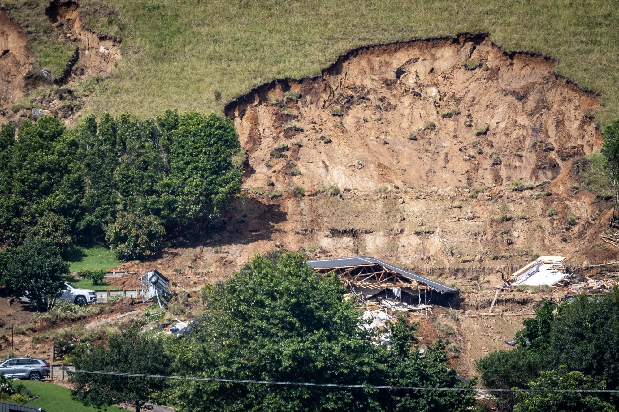 The scene of a double fatality on Welcome Bay Rd when a landslide hit a property on Thursday. Photo / Michael Craig