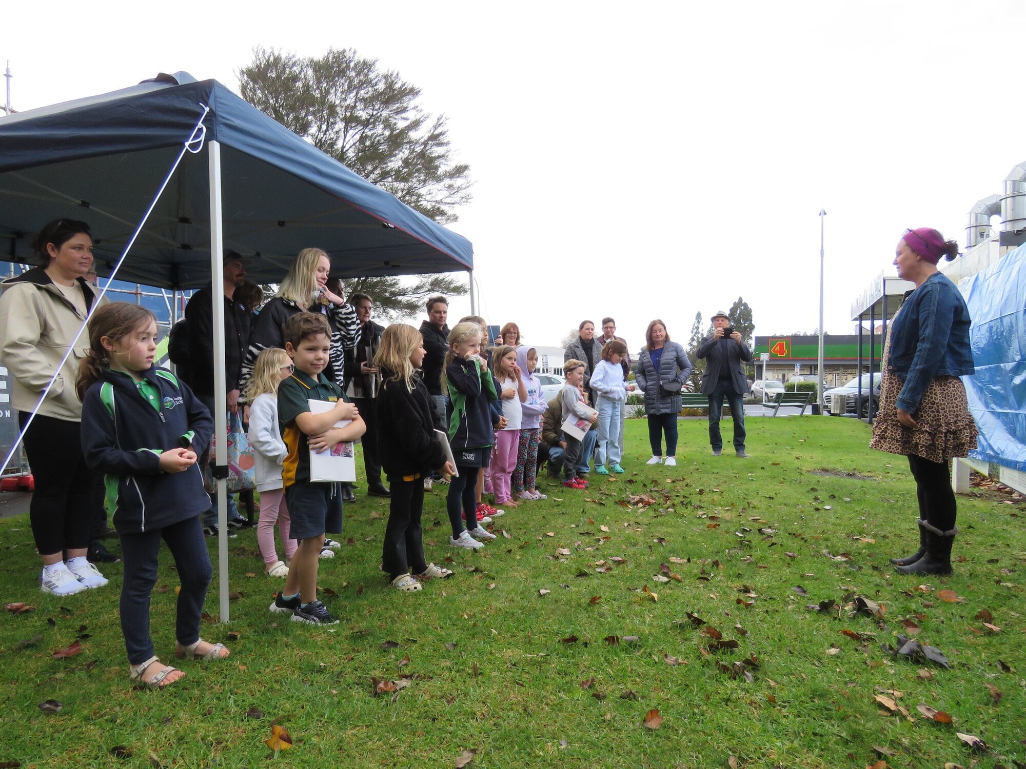  The moment children and their whanau gathered to see the murals unveiled, outside The Arts Junction. Photo / Merle Cave