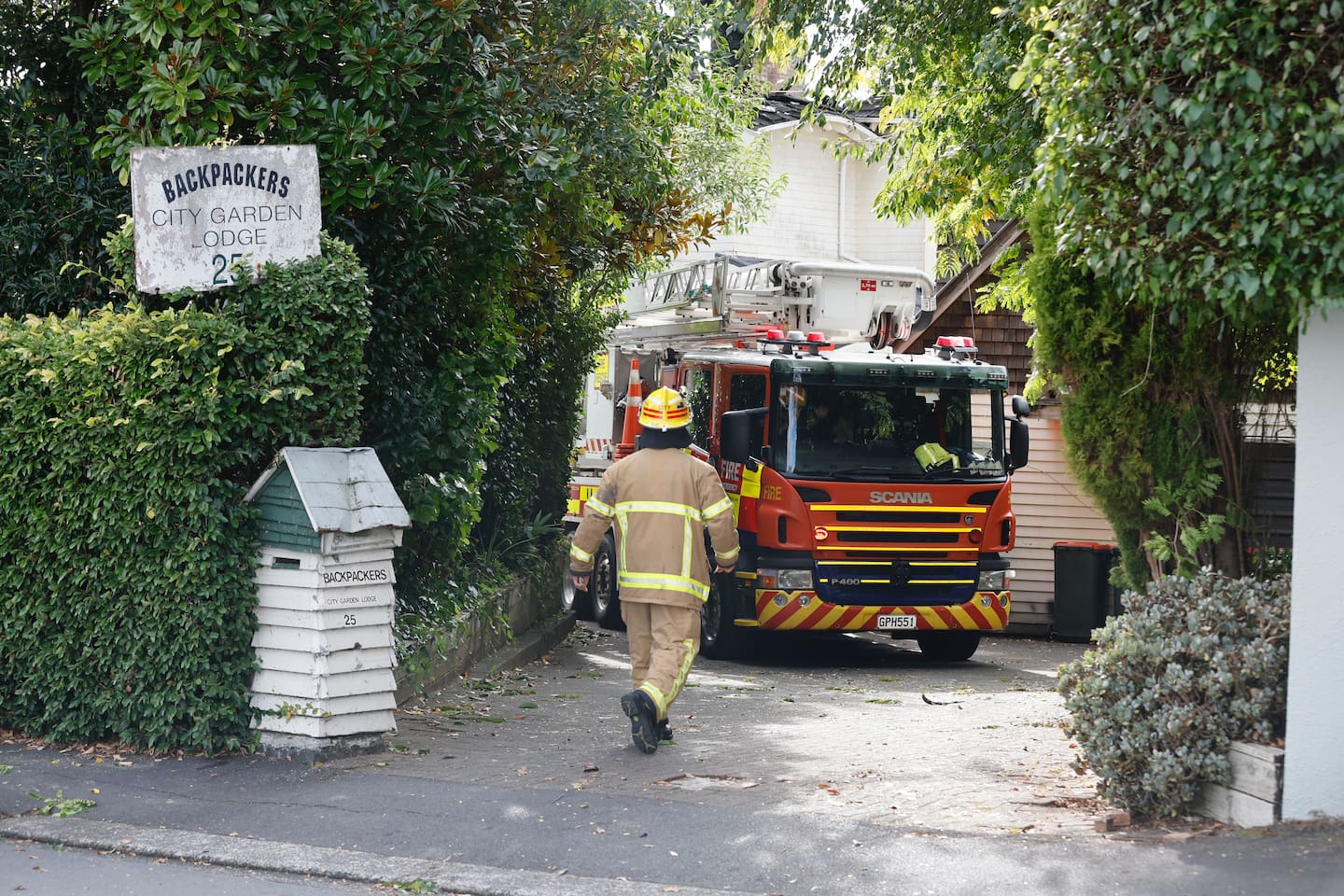 Firefighters are back at the Parnell lodge which was badly damaged by fire yesterday. Photo / Michael Craig