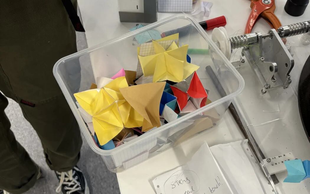 Ella Fasciana used origami paper to begin tackling the problem of how to make a foldable, floating device that could also reflect radar. Photo / RNZ, Claire Concannon