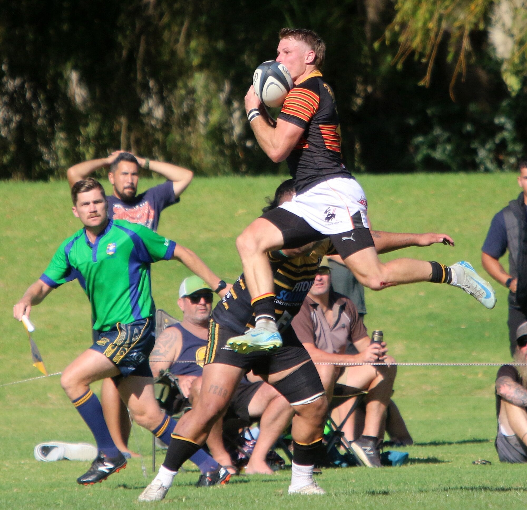 Declan Barnett flies high to catch a cross-field kick. Photo / Stuart Whitaker