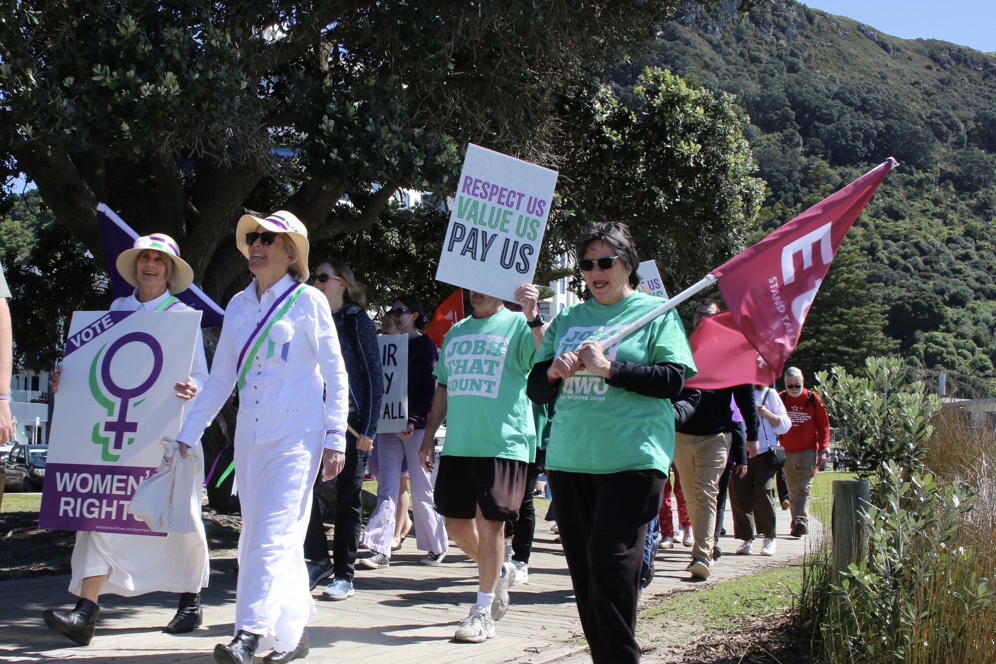 Protestors marching for pay equity along the boardwalk between Mount Drury and Mauao at Mount Maunganui on Saturday, September 20. Photo / Evie Thorne