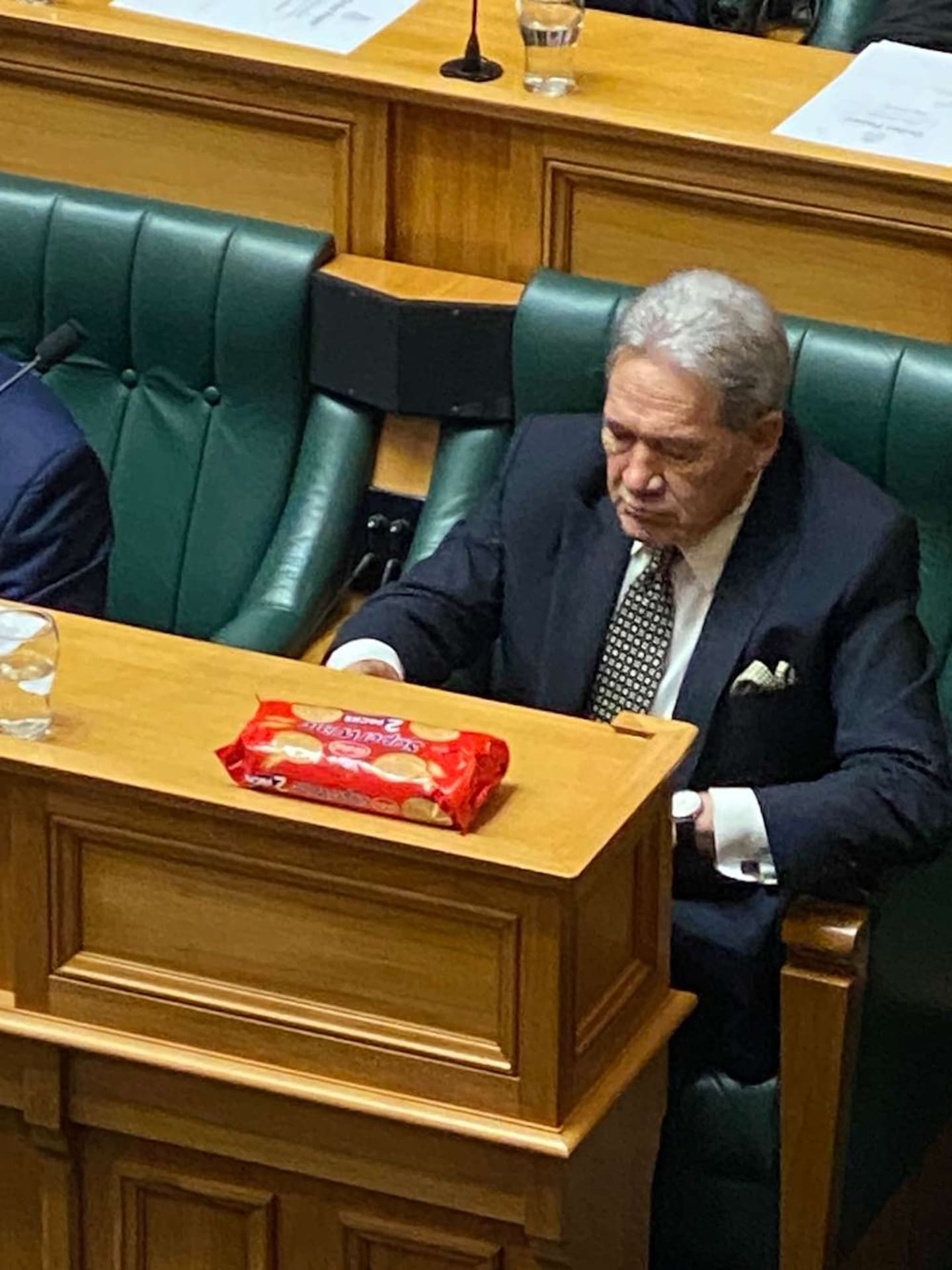 Deputy Prime Minister Winston Peters appears to have a sleeve of wine biscuits with him in Question Time. March 19, 2024. Photo / Mark Mitchell