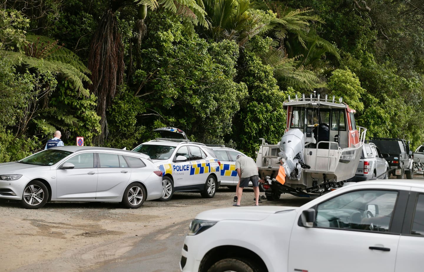 Police and ambulance at Huia after a fishing boat overturned on the Manukau Bar. Photo / Alex Burton