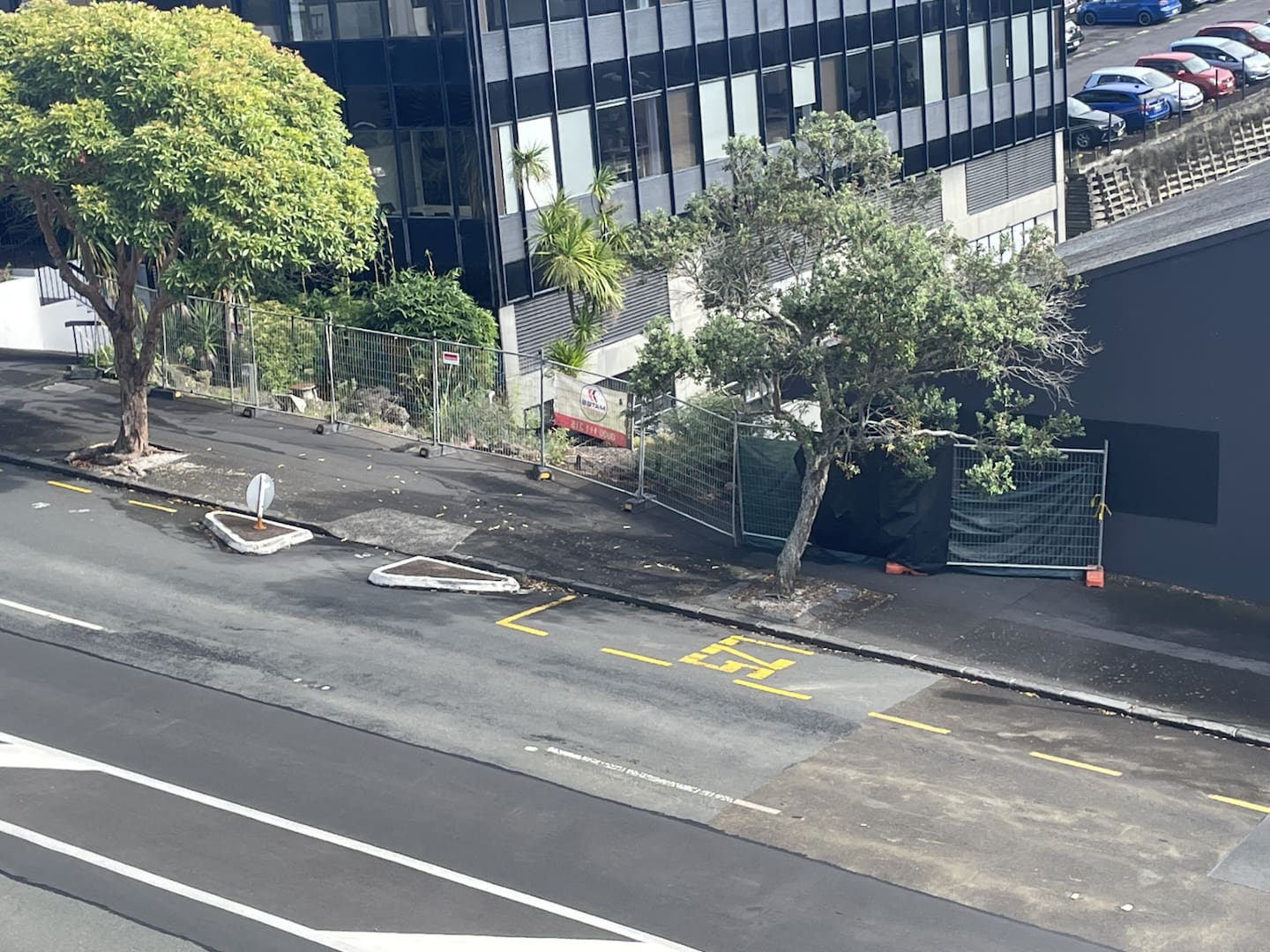 A fence is blocking the footpath, forcing e-scooter users to use the dangerous road.