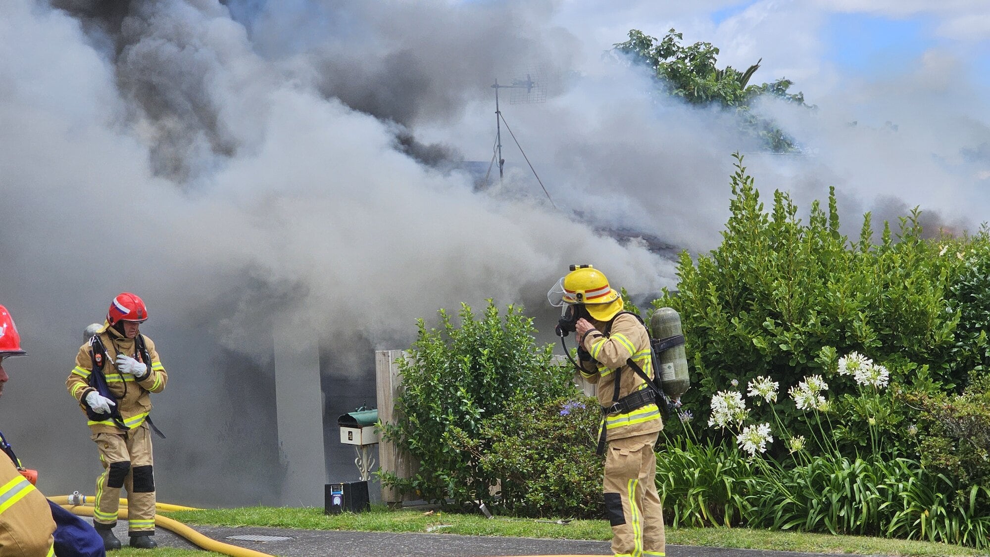 Firefighters at a house fire in Welcome Bay. Photo / Cameron Avery