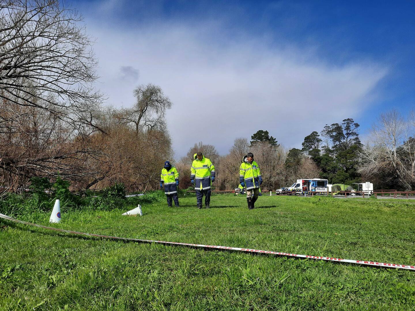 Police hunt for evidence three days after they were first notified of a burnt-out car at River Road Recreational Reserve. Photo / Neil Reid
