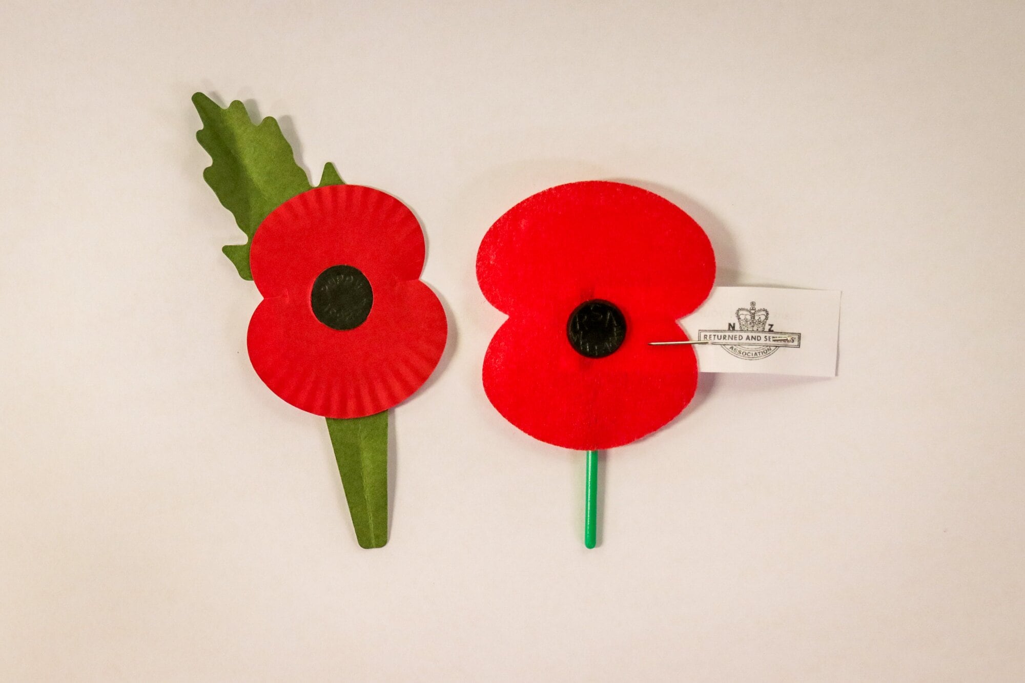 The new poppy design with leaf set at 11 o&rsquo;clock and the previous poppy design.  Photo / Kelly O&rsquo;Hara
