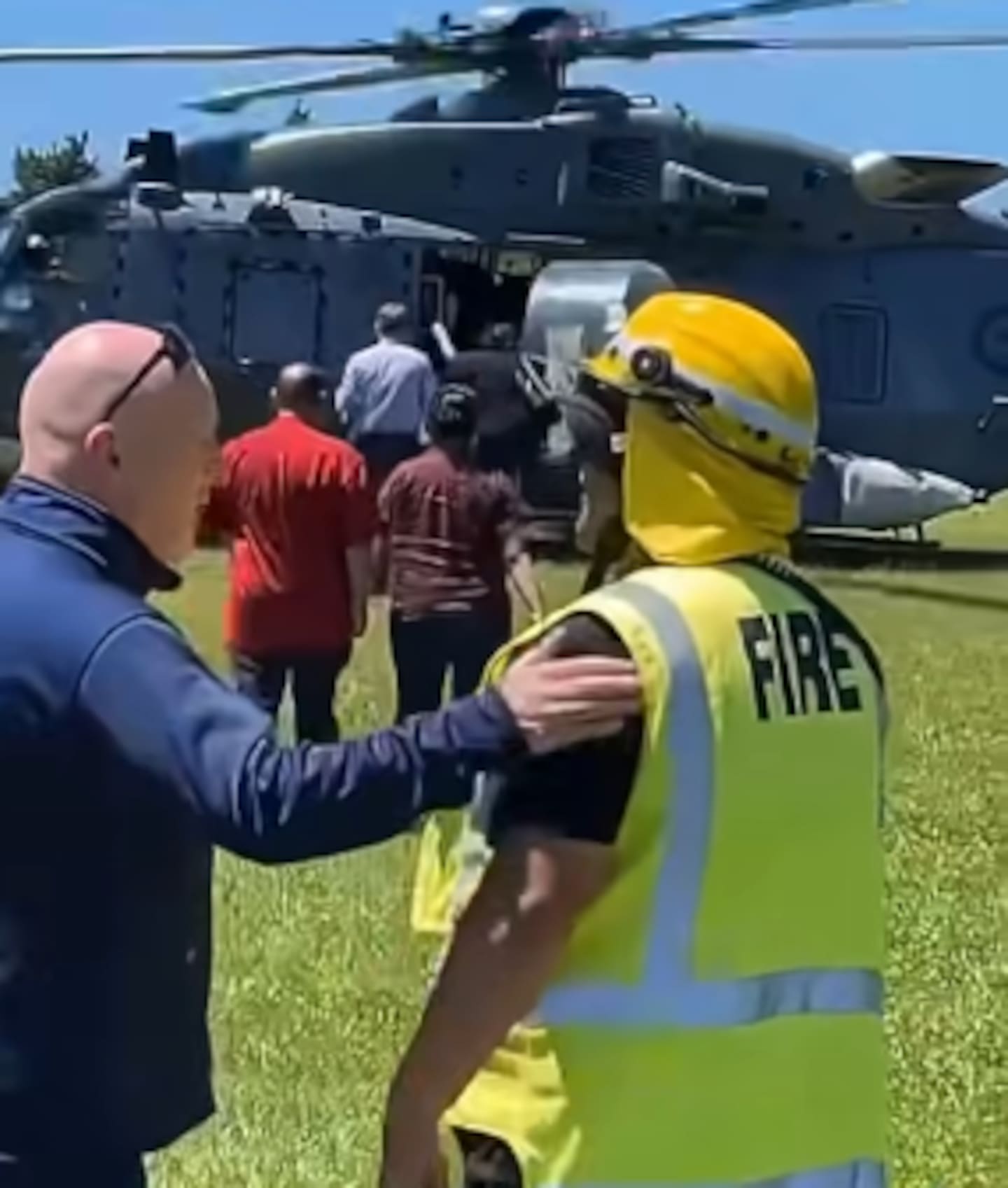 Prime Minister Christopher Luxon was filmed speaking to the person and patting their arm before they made a crude gesture behind his back.