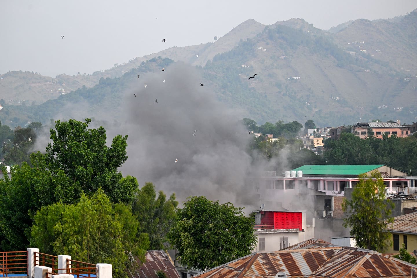 Smoke billows after an artillery shell landed in the main town of Poonch district in India's Jammu region. Photo / AFP