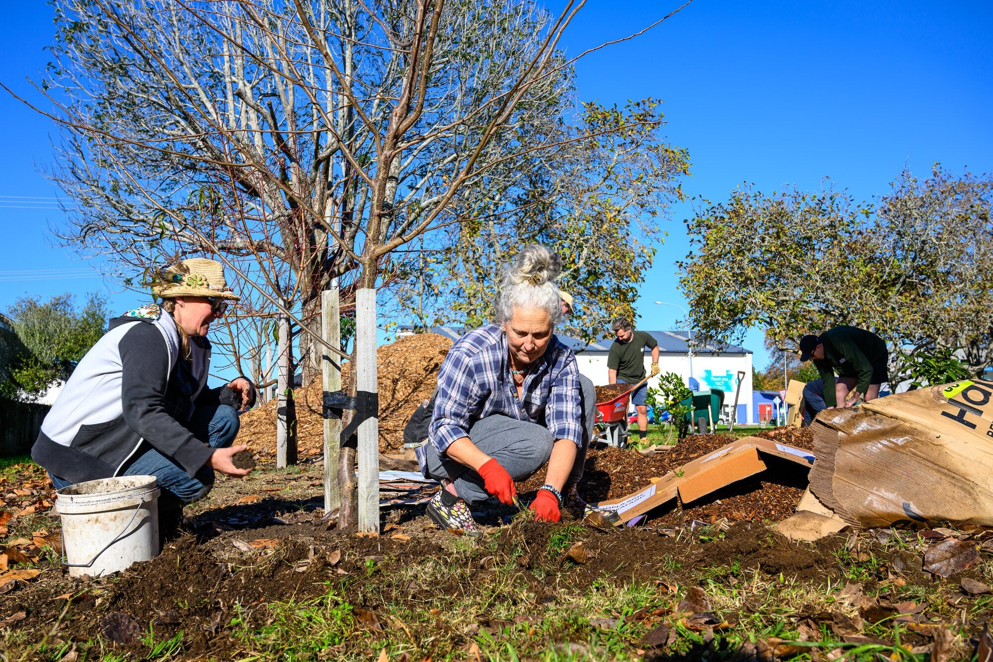  A Colliers team member talks to Jizzy Green (right), about Grow On Katikati. Photo / David Hall