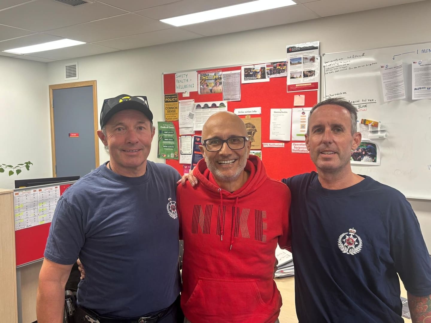 East Coast Bays station officer Martyn Baker (left) and senior firefighter Stefan McCord (right) with Steve Ramdhanie, who was revived after he collapsed while cycling.