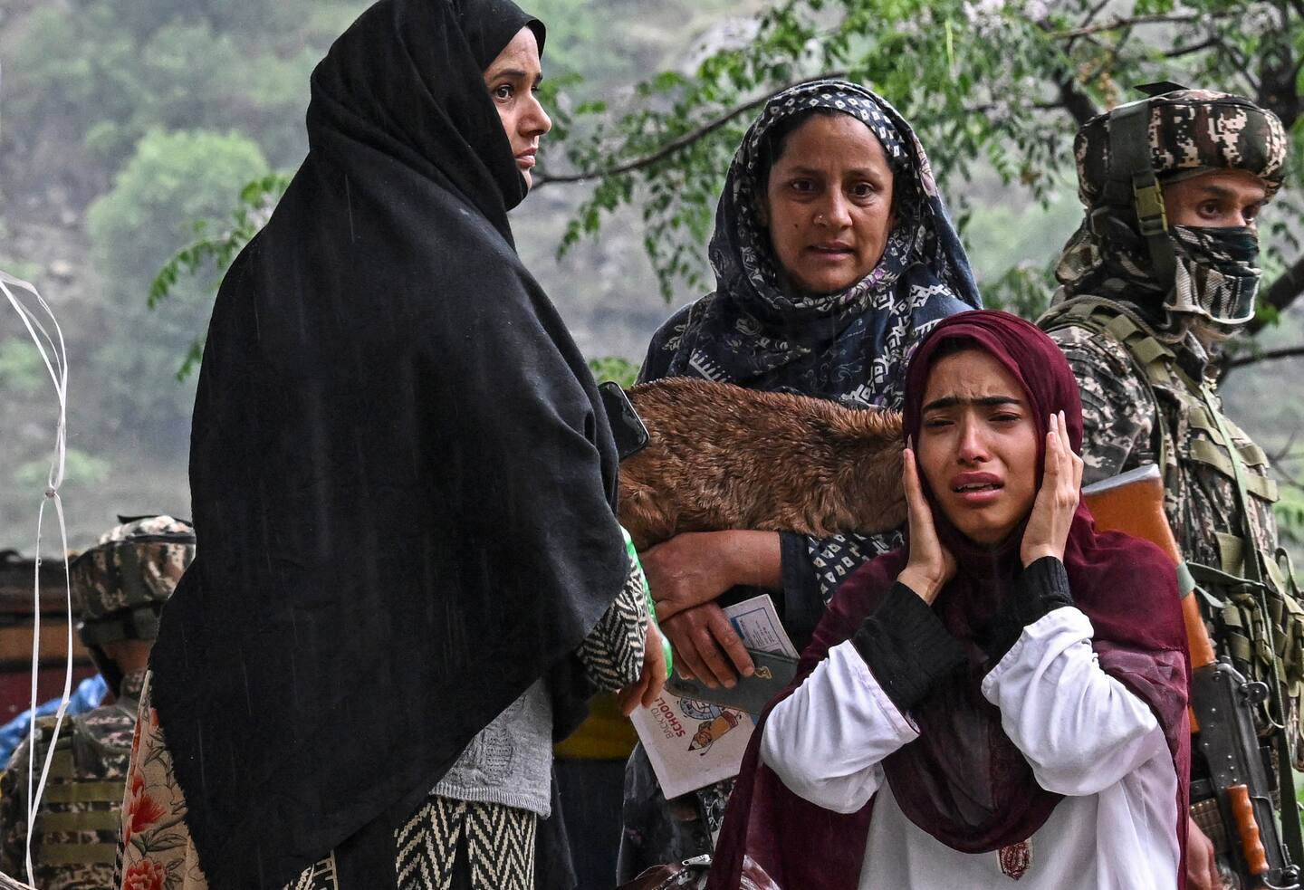 Indian villagers react while waiting for transportation as they evacuate after overnight Pakistani artillery shelling in Uri, about 100km from Srinagar. Photo / AFP