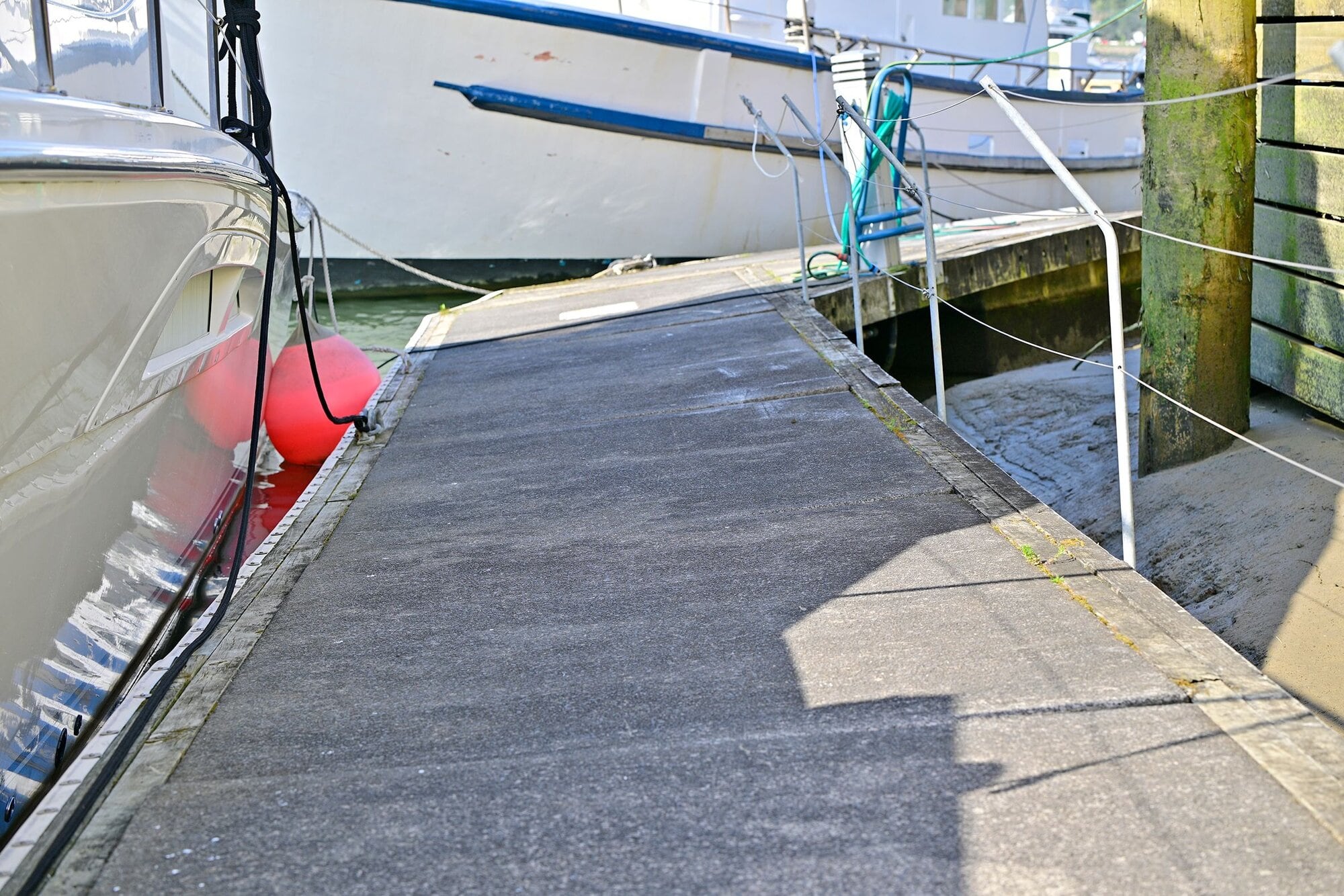  A pontoon walkway used to reach berths is dangerously tilted on its side, causing it to be damaged. Photo / LDR