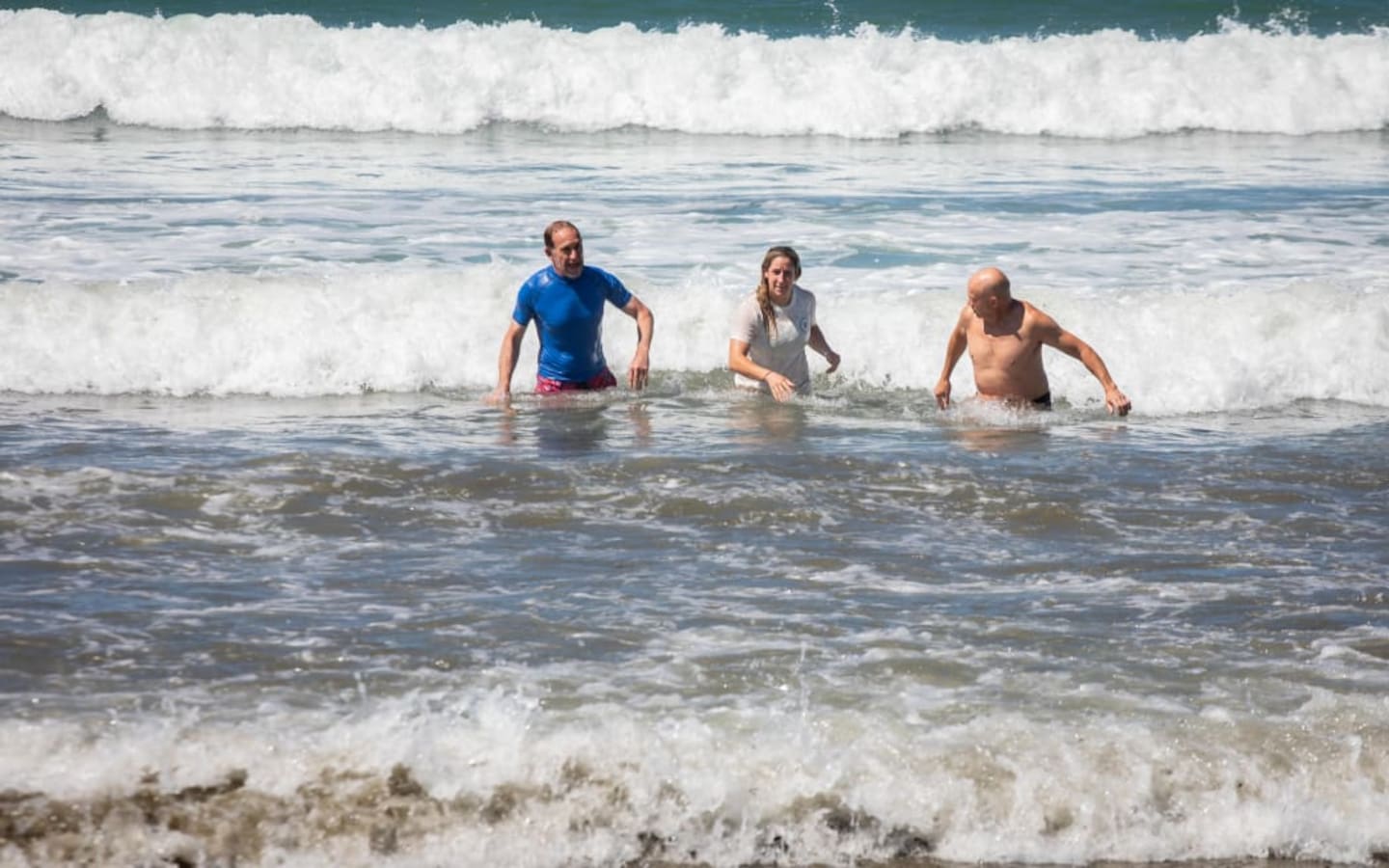 Wellington Mayor Andrew Little (left) swims in Lyall Bay after announcing the lifting of a swimming ban. Photo / Mark Papalii, RNZ