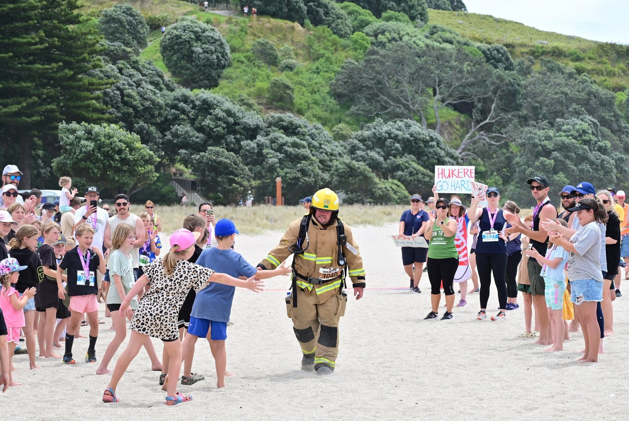  Volunteer firefighter Chris Reid on Mount Maunganui Main Beach in Tauranga's City to Surf last year. Photo / Marathon Photos Live