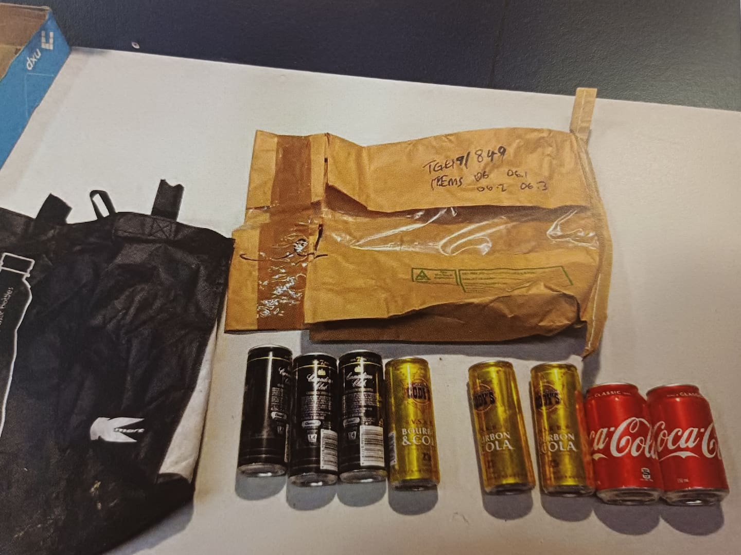 Cans seized from a suspected clan lab that the Crown says provide a link to the occupants who were living next to where the lab was uncovered in dense bush.