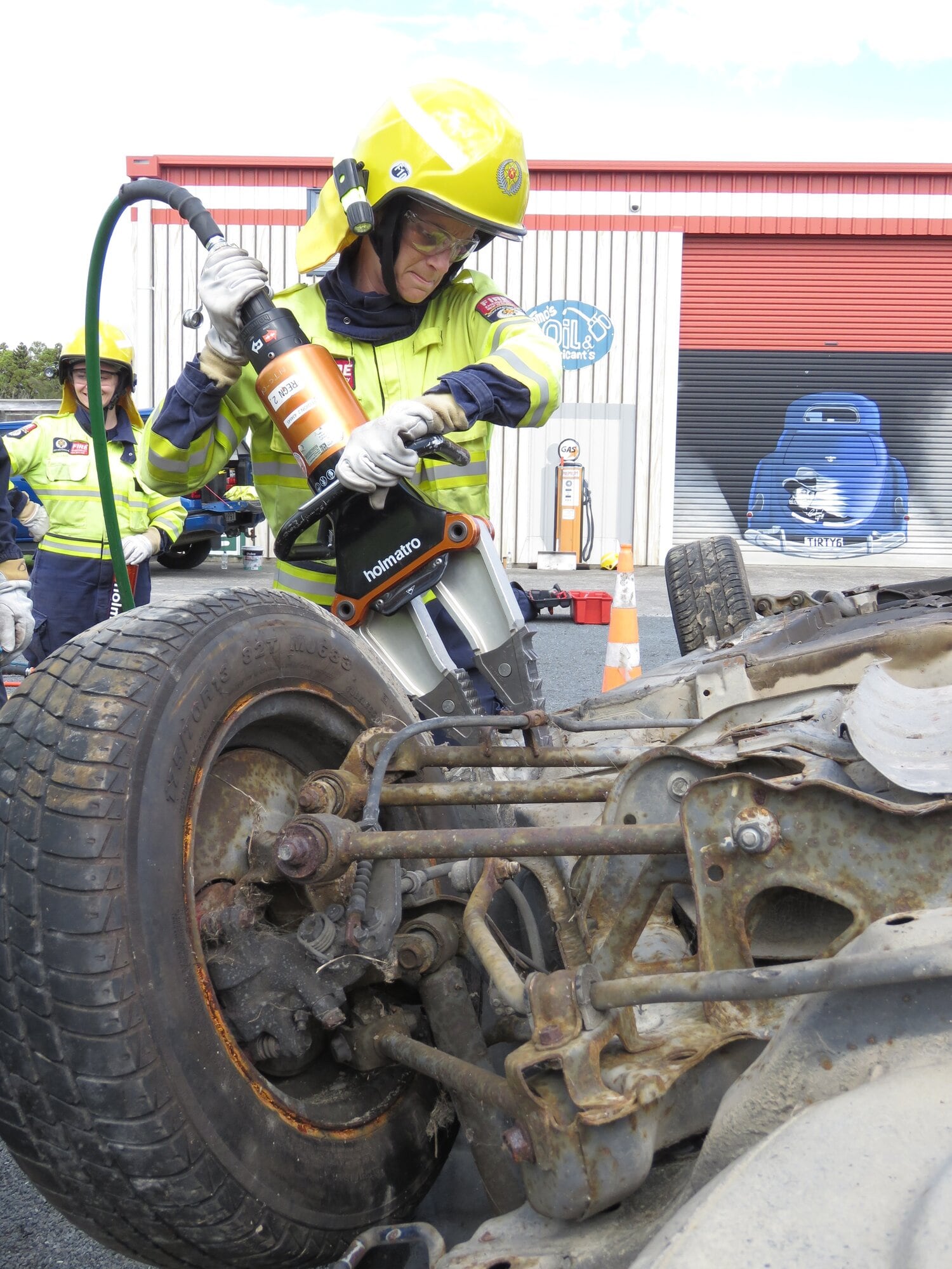  Katikati volunteer firefighter Danielle Lister using the jaws of life in a Motor Vehicle Extrication (MVE) course this month, as fellow trainees watch on. Photo / Merle Cave