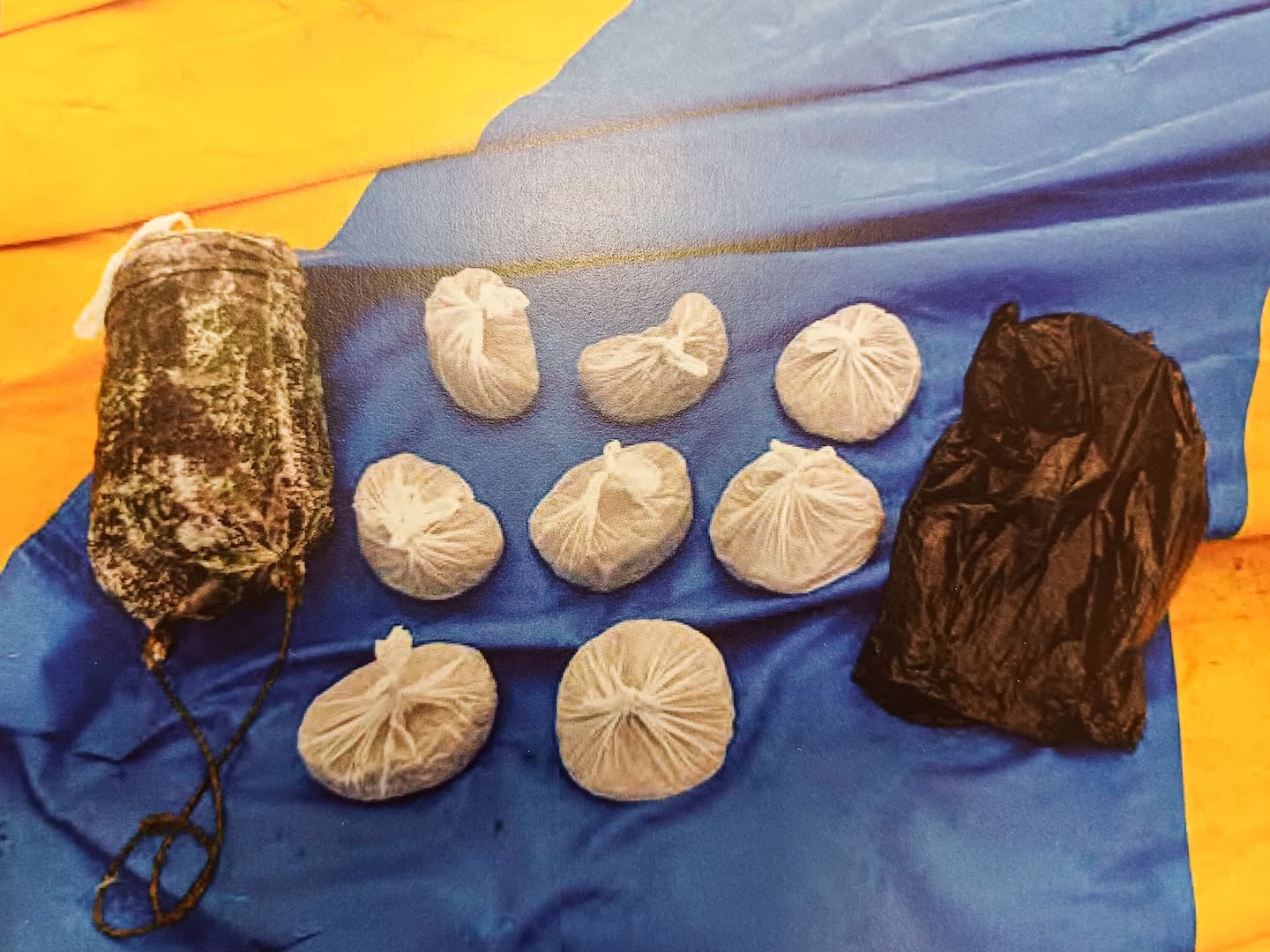The Crown alleged the black and green spraypaint on the sacks covering buckets of cannabis, hidden in the undergrowth, provided a link to a couple charged with possession of cannabis for sale.