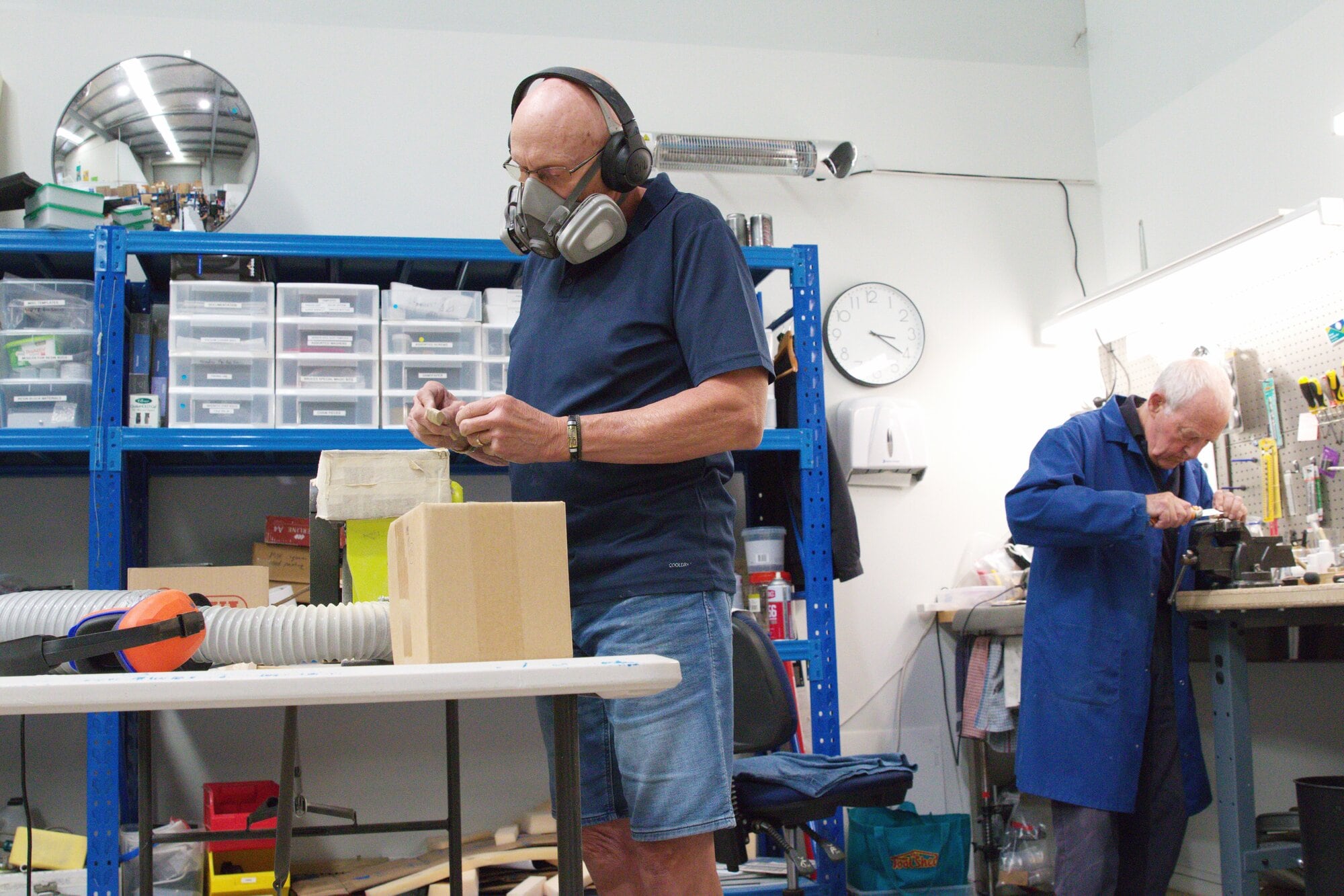  Tony Weigel wearing a mask, and Bruce Henderson in the House of Science workshop building components for the science kits. Photo / Kelly O&rsquo;Hara