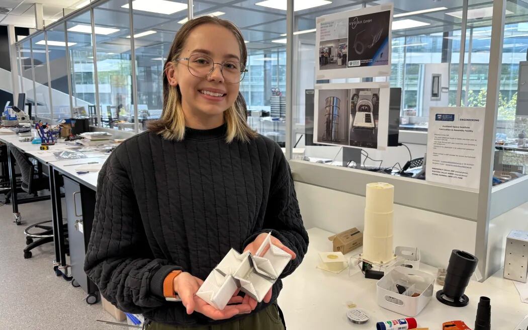 Space Institute research assistant Ella Fasciana with a small model of the current SAR4SaR prototype. Photo / RNZ, Claire Concannon