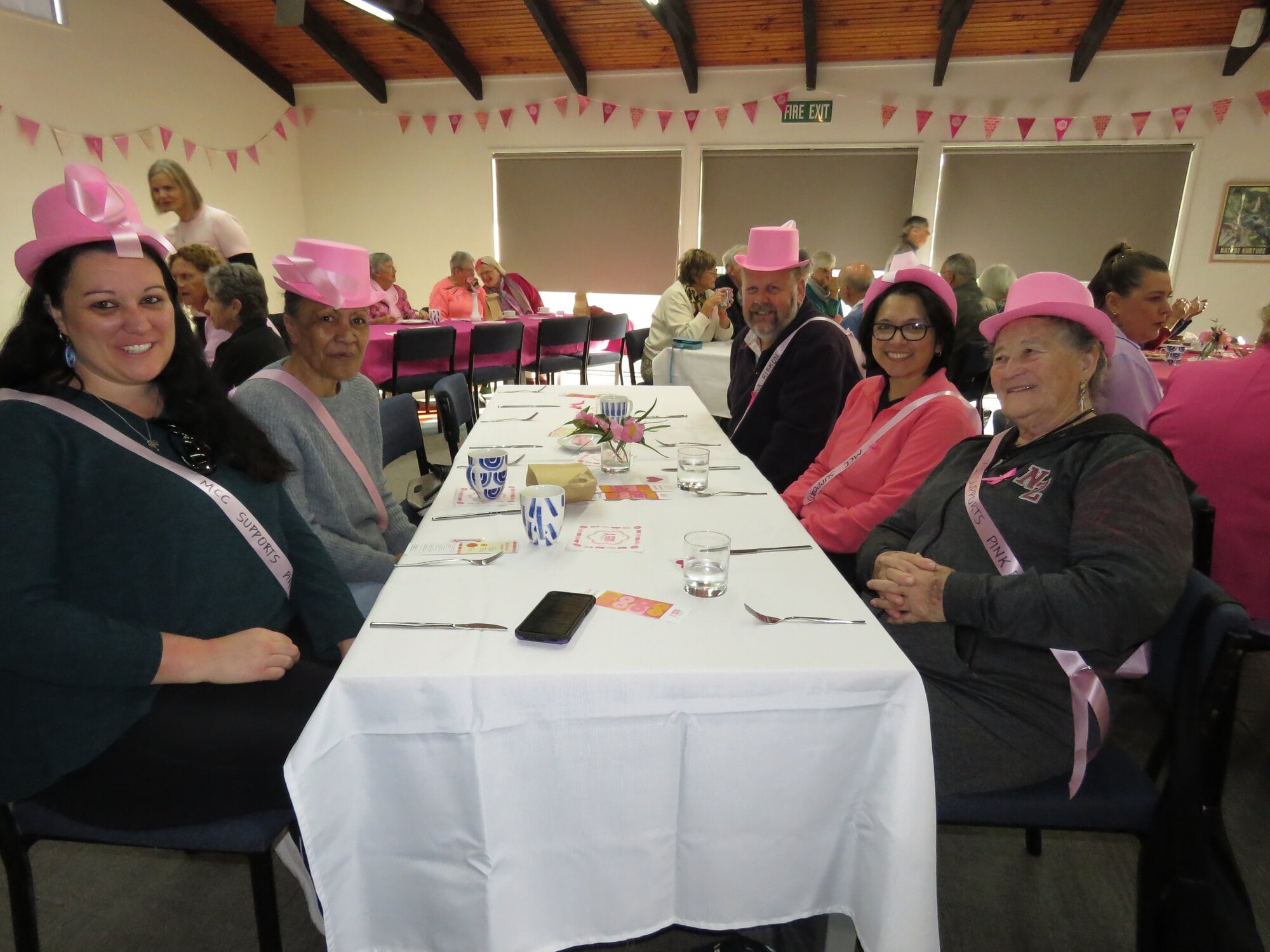 Merivale Community Centre staff wore pink hats when they came out to Katikati to support the fundraising of a fellow community centre. Photo / Merle Cave