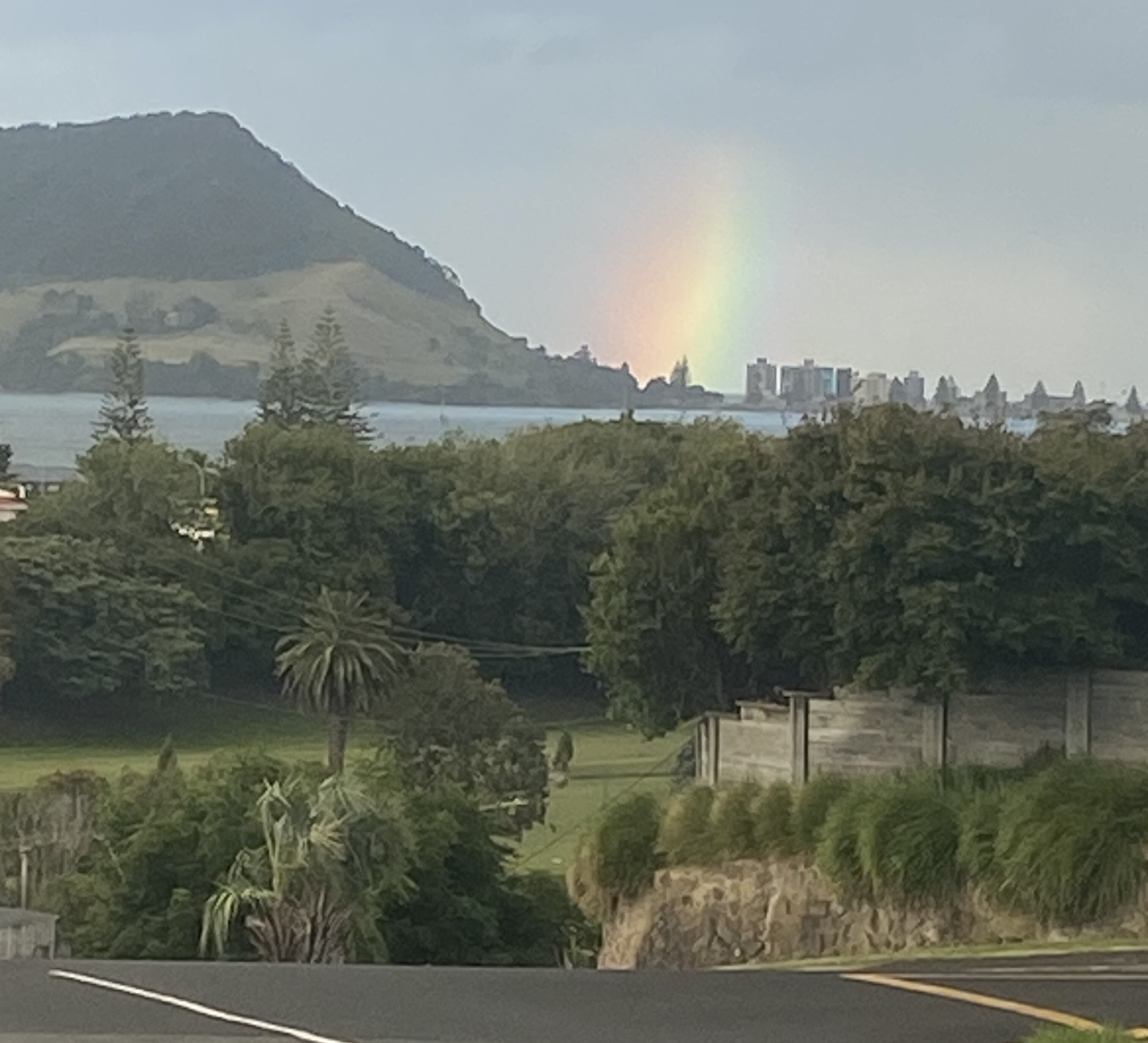 A rainbow appeared over the Mauao landslide site at Mount Maunganui on Saturday night. Photo / Tom Christie