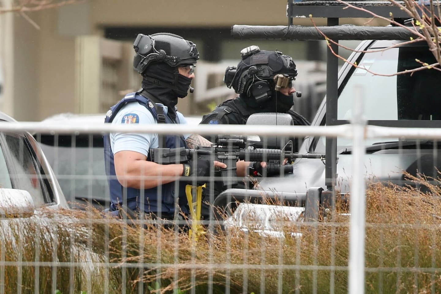 Armed police officers surround a property after a police officer was shot in Flat Bush, South Auckland. Photo / Jason Dorday
