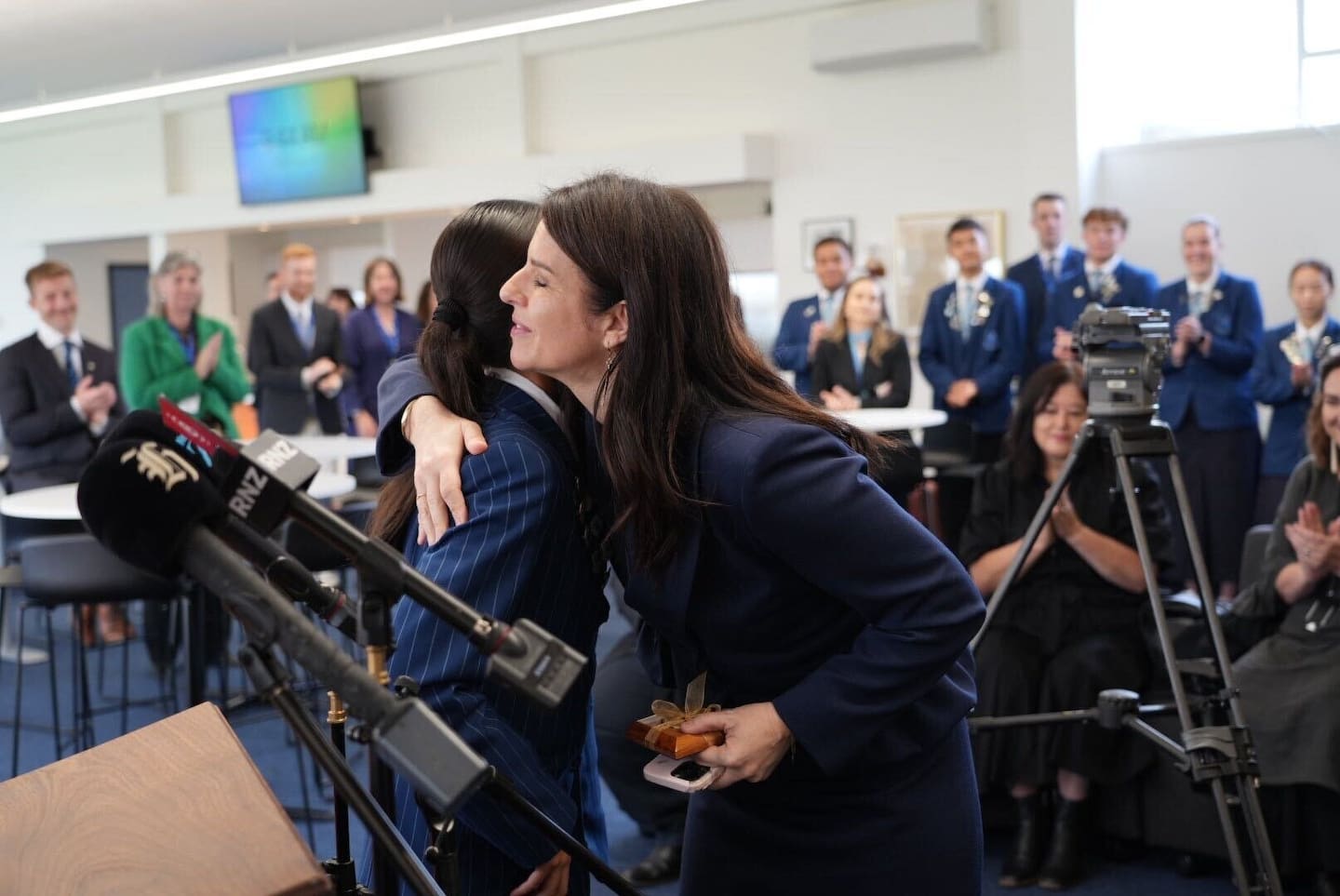 Education Minister Erica Stanford hugging a student at Mt Albert Grammar, after she
received a gift from the school ahead of her announcement of a boost in teacher and learning support staff numbers. Photo / Alyse Wright