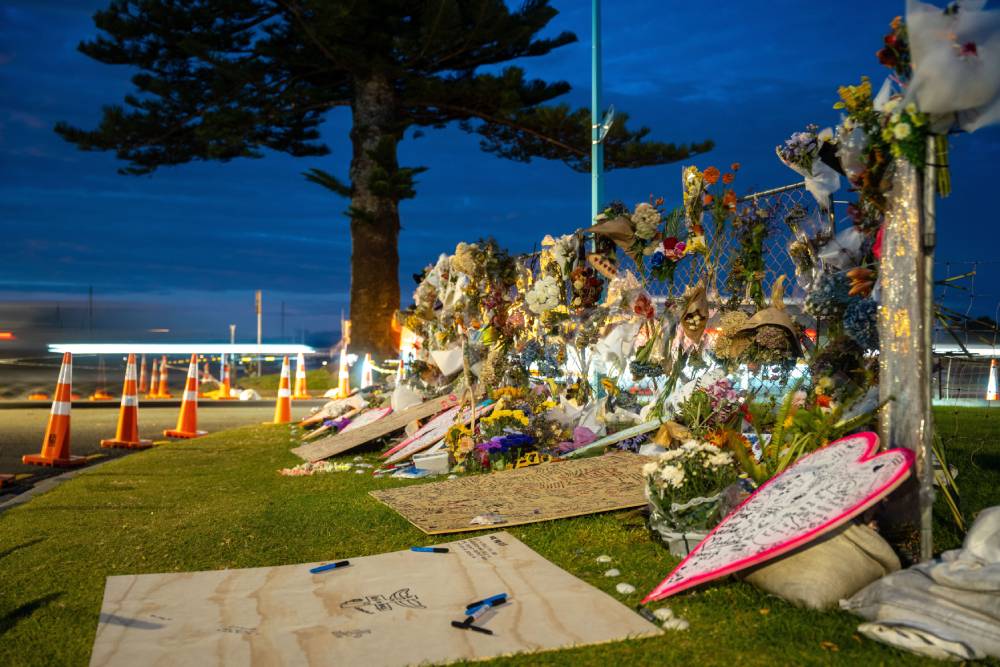 Flowers at a memorial set up at the landslide cordon at Mount Maunganui. Photo / Corey Fleming