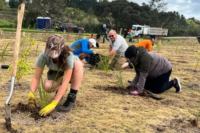 Sylvie Brown from ACG, Geoff Brown (at back), and Karpaga Kanniya Muthu helping plant 4500 native plants in Kōpūrererua Valley in September, 2024. 