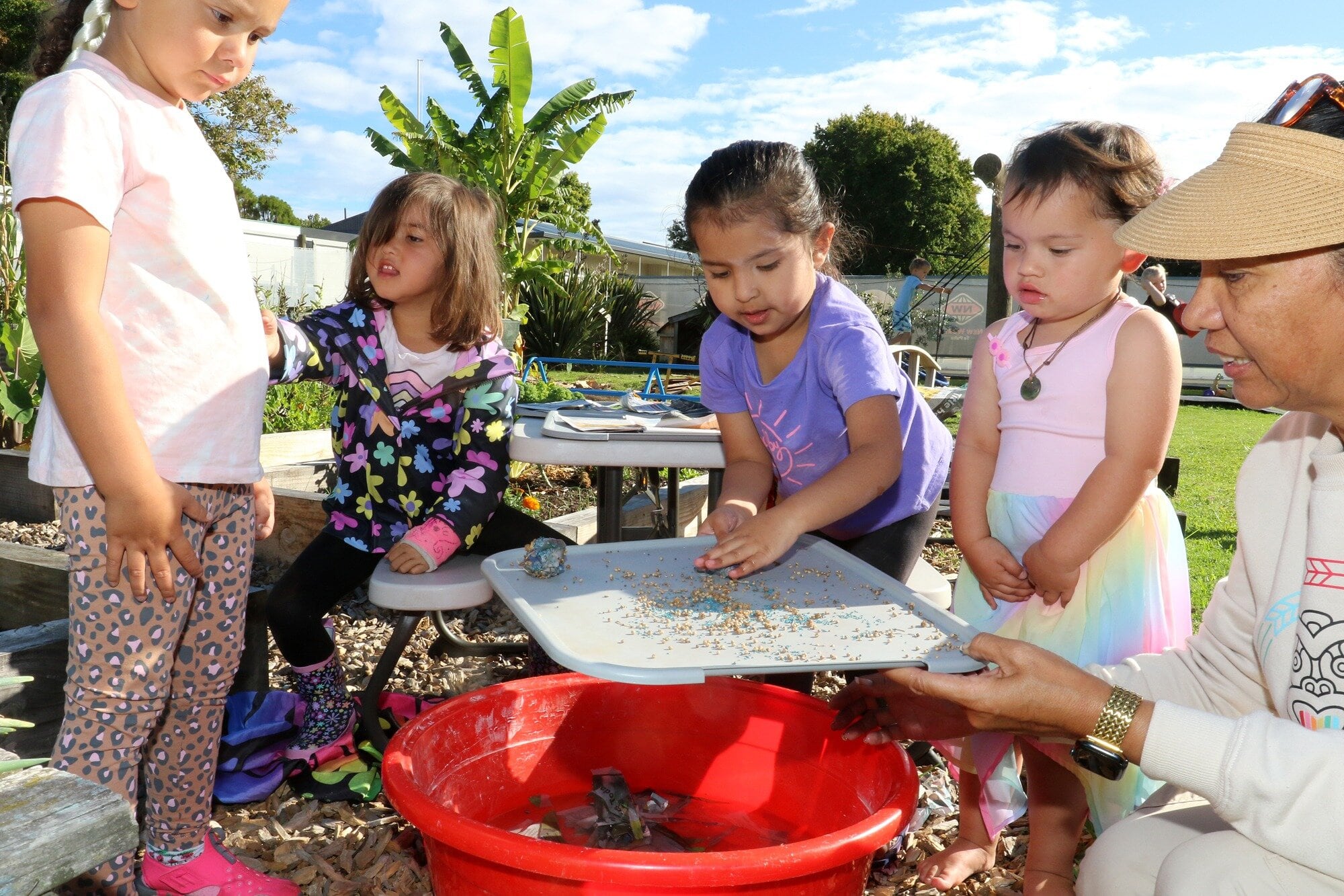  Tamariki at Giggles early Learning centre practicing making seed balls. Photo / Stuart Whitaker