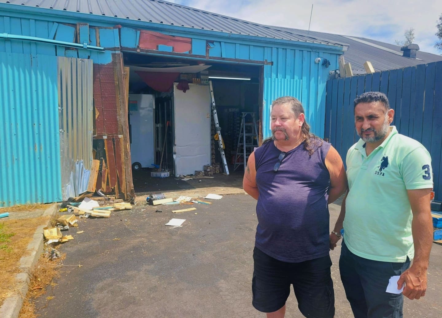 Westbrook Liquor Centre owner Ranjit Singh (right) and manager Chris Williams survey the damage after a ram raid at the store. Photo / Ben Fraser