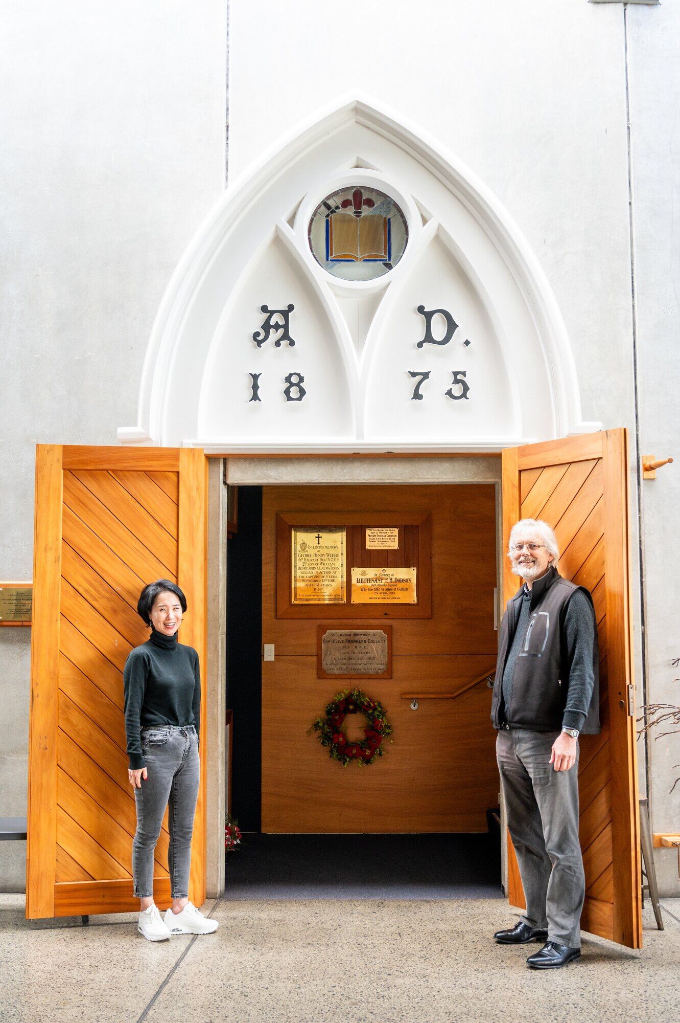 Holy Trinity Tauranga facility manager Jackie Kim and Parish Pastor Donald Carter at the entrance to the Memorial Alcove off the lobby, where the laid-up colours of the Sixth Hauraki Regiment are placed. Photo / Brydie Thompson.