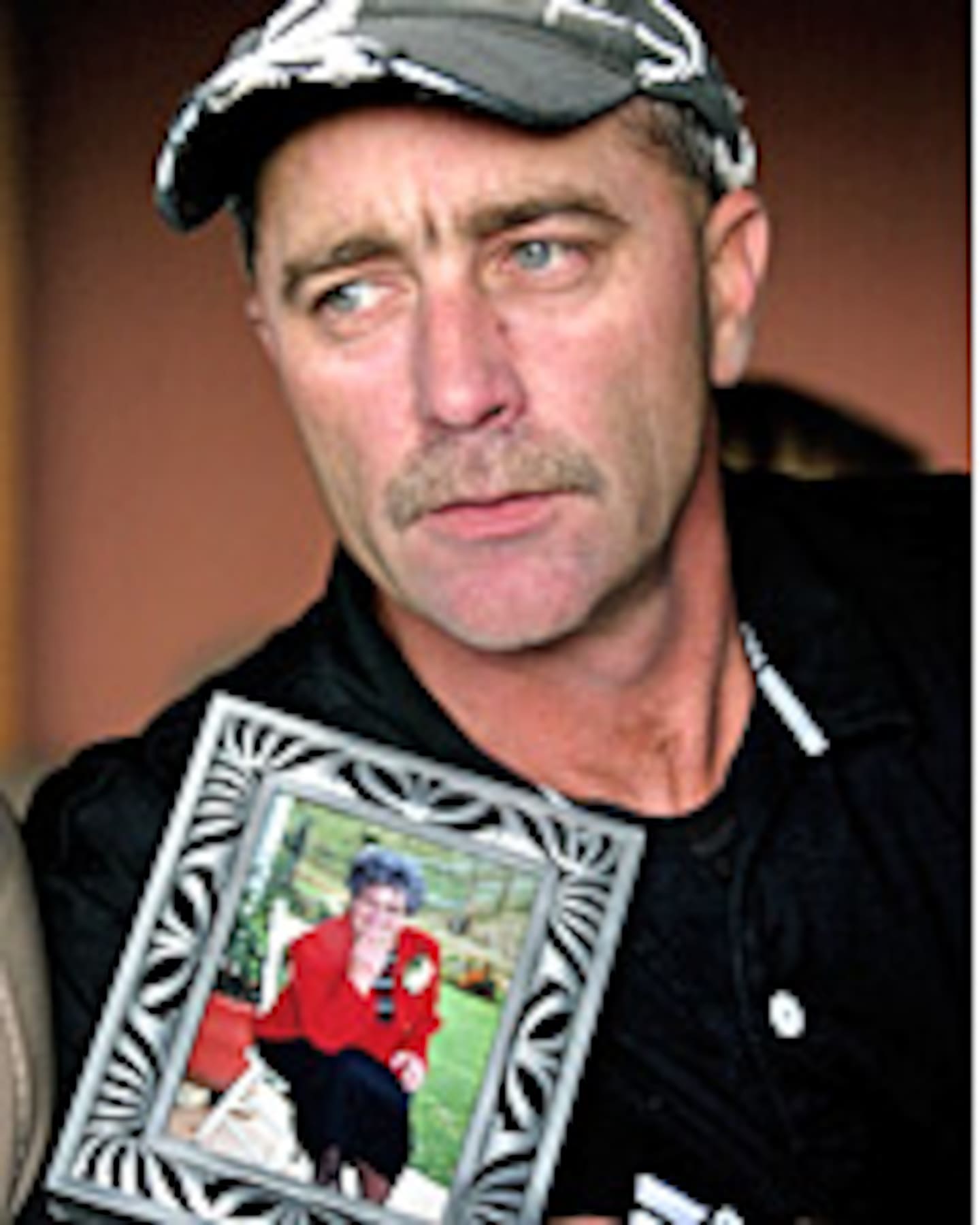 Kevin McNeil with a photo of his mother Lois Dear. Photo / NZME