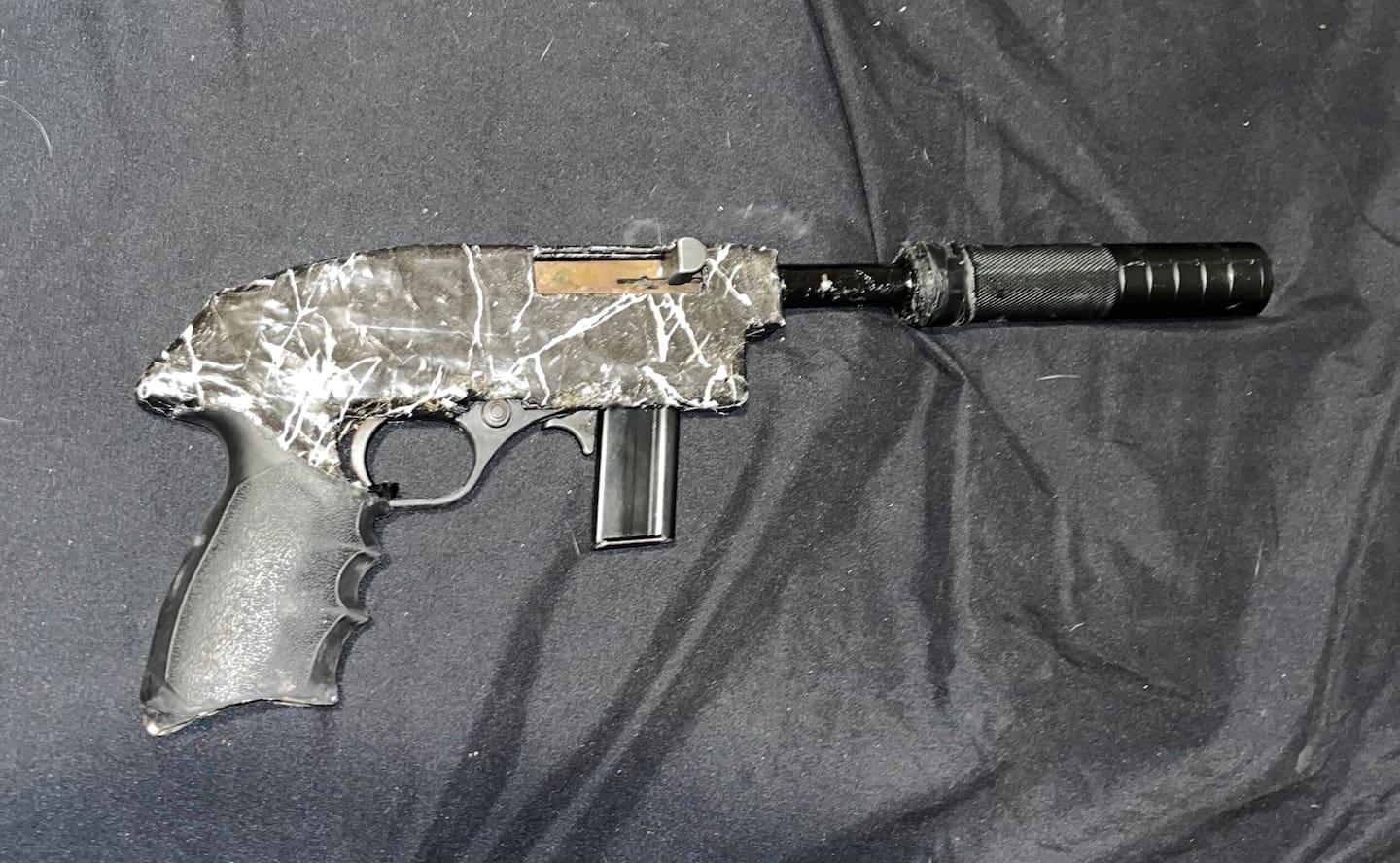 Police have seized a stash of guns, ammunition, cash and illicit drugs in raid in Central Auckland this morning, with two people facing charges. Photo / NZ Police