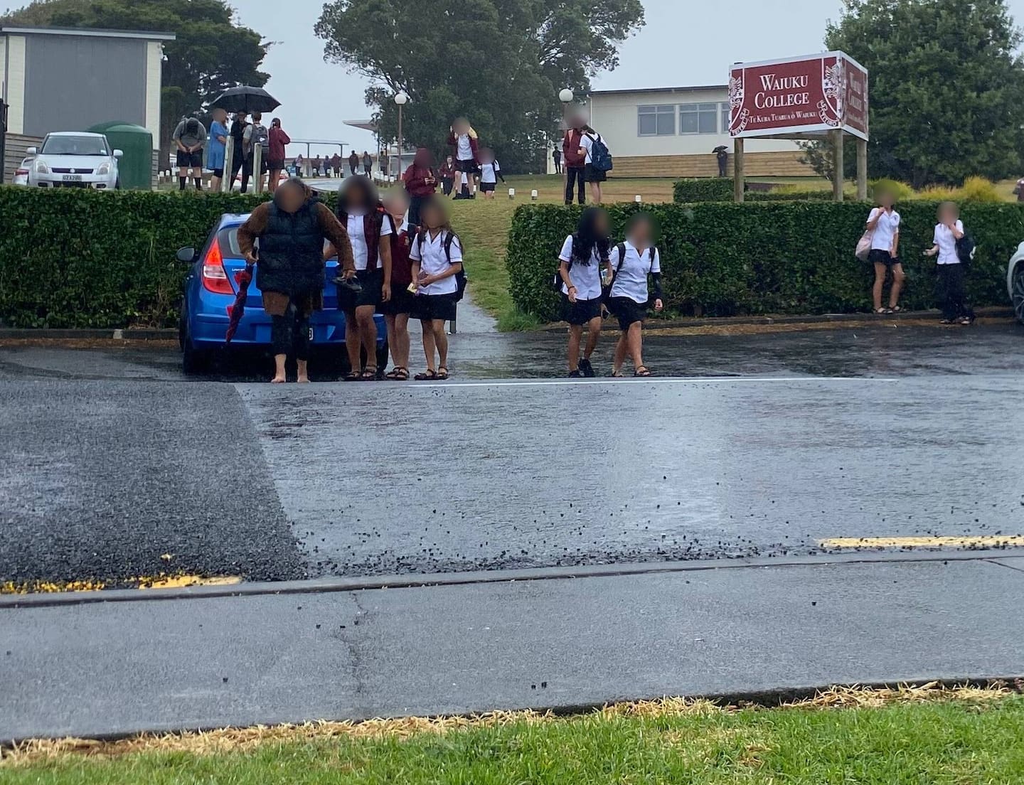 Students exit Waiuku College on Wednesday after the school was forced to close for the day following a threatening email. Photo / Cherie Howie