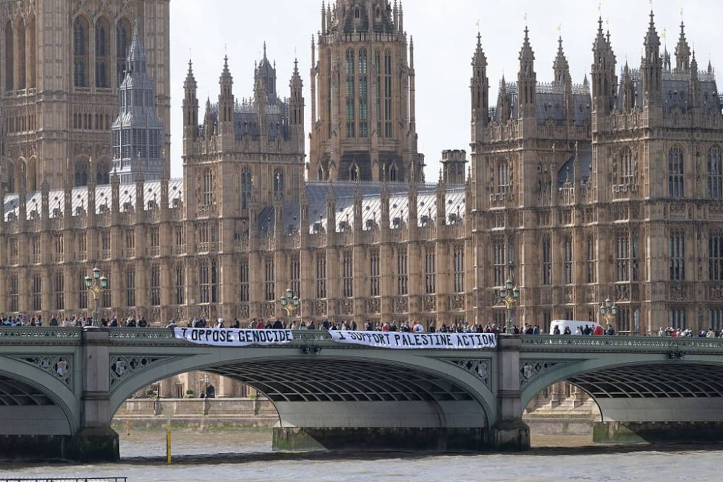 Activists hang a banner in support of Palestine Action from Westminster Bridge in London. Photo / Getty Images