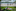 A woman stretches up her hand while laying in a patch of shade with books at Yards Park, Sunday, June 16, 2024, as temperatures begin to steam up in Washington. Photo / AP