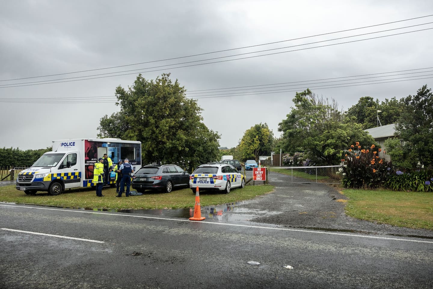 Police at the property on Waitārere Beach Rd following a shooting that left a man dead and three others in hospital. New Zealand Herald photograph by Mike Scott